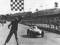 Sir Stirling Moss , shared with Tony Brooks, wins the 1957 British Grand Prix in the Vanwall - the first all British - Grand Prix win